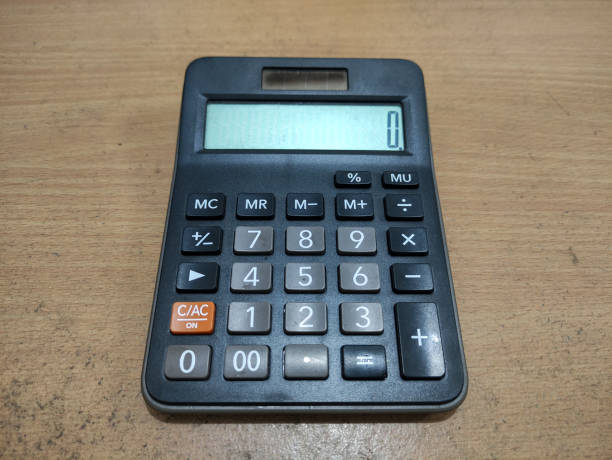istock Black Electronic Calculator on Wooden Desk with Clear Digital Display 2199603324