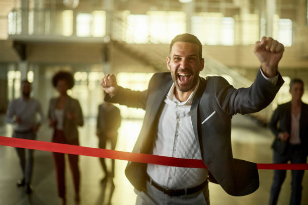 istock Joyful businessman celebrating his victory in office race. 2199603471