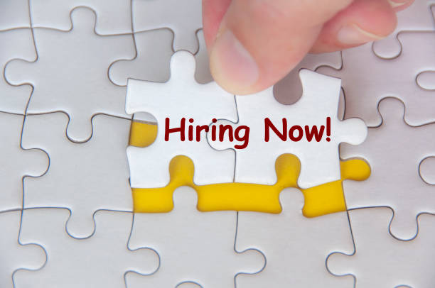 istock Hand holding jigsaw puzzle with Hiring Now text. Recruitment and Hiring concept 2199605411