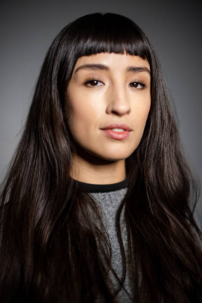 istock Studio portrait of woman with neutral expression 2199609382