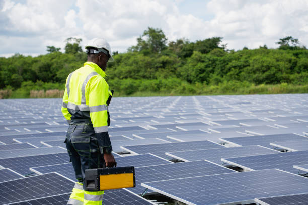 istock Engineer checking solar panels on a floating buoy. The power plant uses water and renewable energy to produce eco-friendly electricity. 2199611517