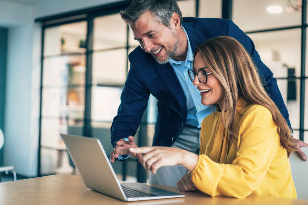 istock Two business coworkers talking 2199612725