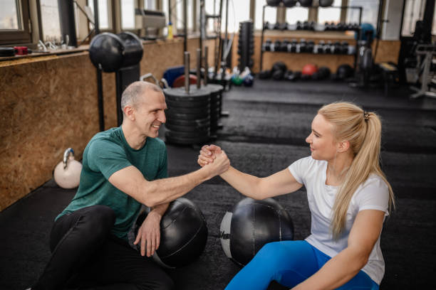 istock adults training together in the gym during a strength challenge for a healthy lifestyle 2199612792