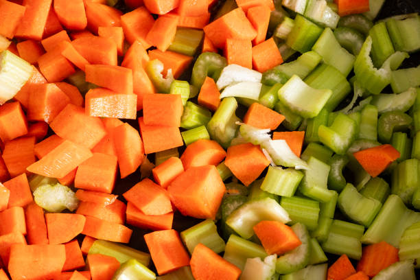 braising carrot celery and onion to prepare italian soffritto - braising carrot celery and onion to prepare italian soffritto - a base for any soup or sauce from Italy braising pan stock pictures, royalty-free photos & images