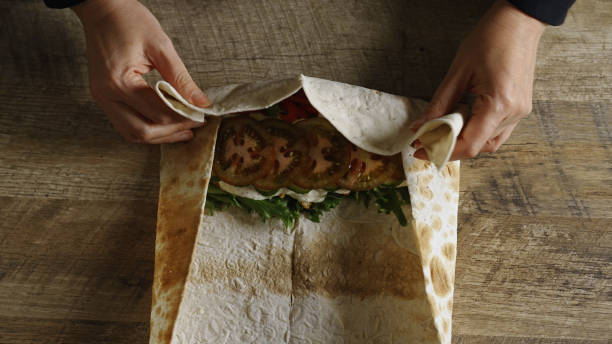 istock Wrapping shawarma in lavash with chicken and vegetables. 2199617023