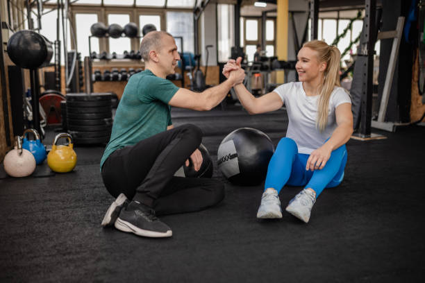 istock Engaged adults participating in arm wrestling in a gym environment focused on strength training and fitness activities 2199617287