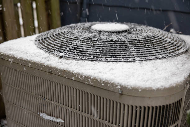 istock Close-Up Heat and Air Conditioning Compressor in a Light Snow 2199617670