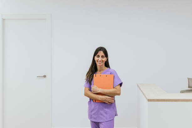 istock Optometrist woman smiling and holding a clipboard in her office 2199619692