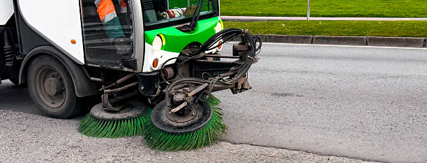 istock Street sweeping vehicle cleans urban road with rotating brushes 2199619861