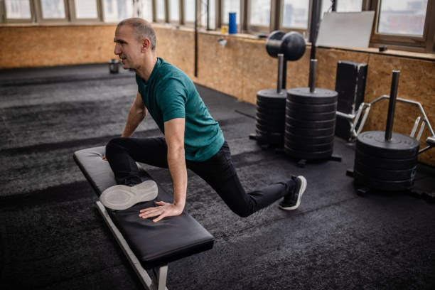 istock Focused adult stretching during strength training session in a modern gym environment 2199619917