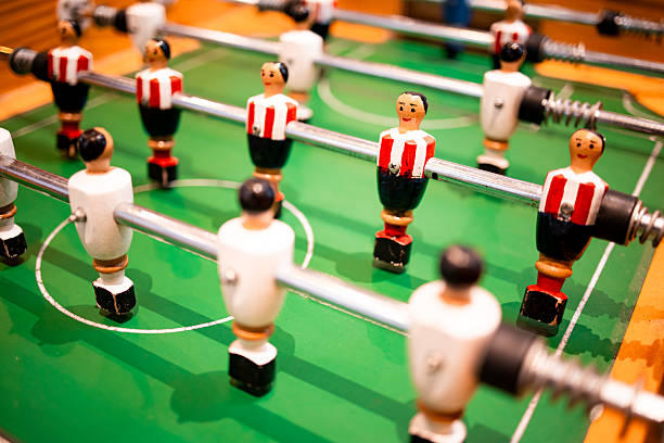 istock Tabletop football game with red and white player figures on green field 2199620018