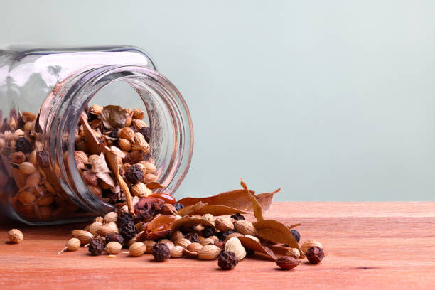 Close-up of organic Cardamom (Elettaria cardamomum). A heap of dried cardamom seeds, isolated on a white background.