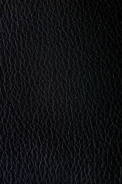 istock Black macro synthetic leather surface,Natural, genuine black leather texture close up, macro. Structure of glossy leatherette, artifical skin surface with embossing pattern. Background, 2199620994