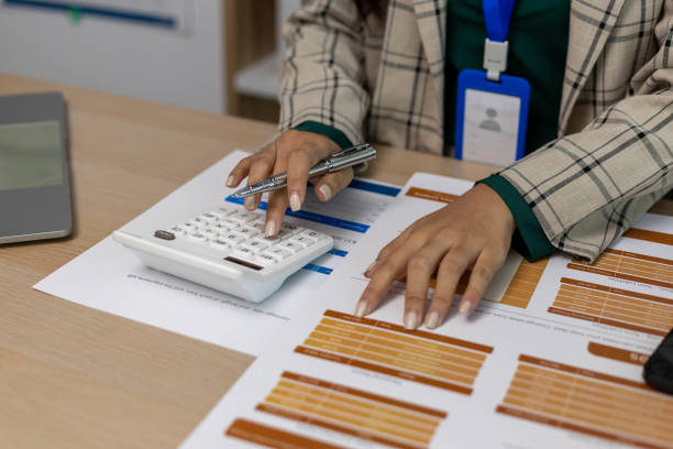 istock A woman is holding a calculator and a pen 2199622397