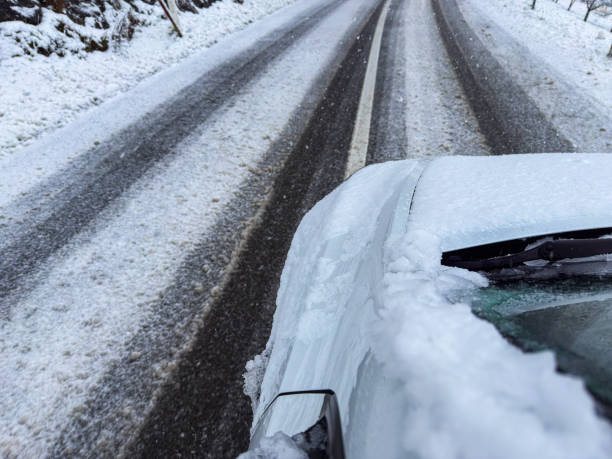 istock Car Driving on Icy Snow-Covered Road with Fresh Tire Tracks 2199623255