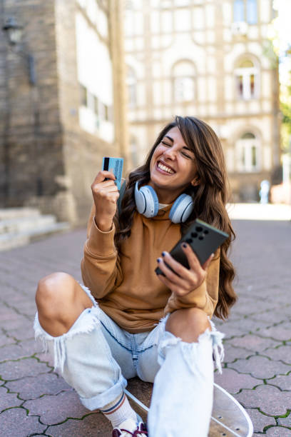istock Young urban woman using phone outdoors 2199623687