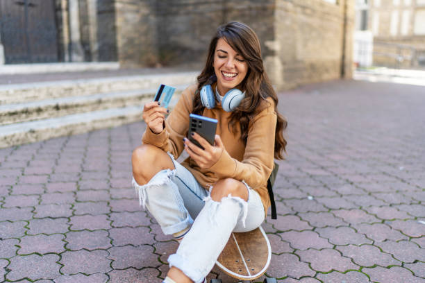 istock Young urban woman using phone outdoors 2199623742