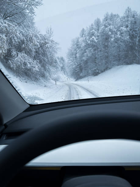 istock Driving Through a Snowy Forest on a Winter Road 2199623824