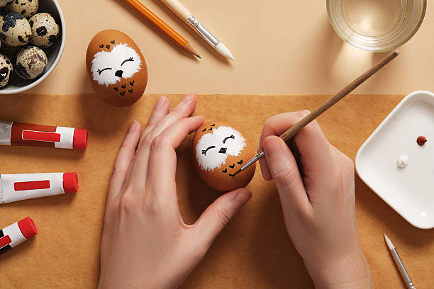 istock DIY and children's art. Step-by-step instructions: how to make cute owl Easter egg. Step 10: Paint the feathers with black paint based on the pencil sketch. 2199625098