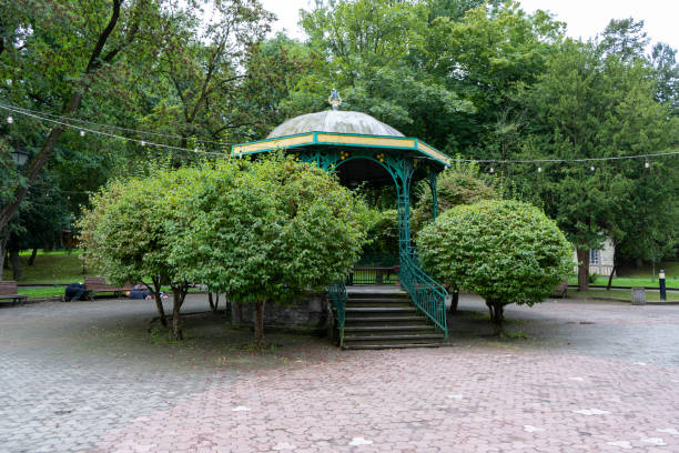 Gazebo on the street. Green trees rest zone