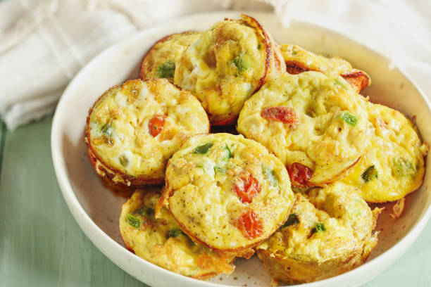 istock Delicious vegetarian egg muffins with tomatoes cheddar cheese and green bell peppers 2199627502