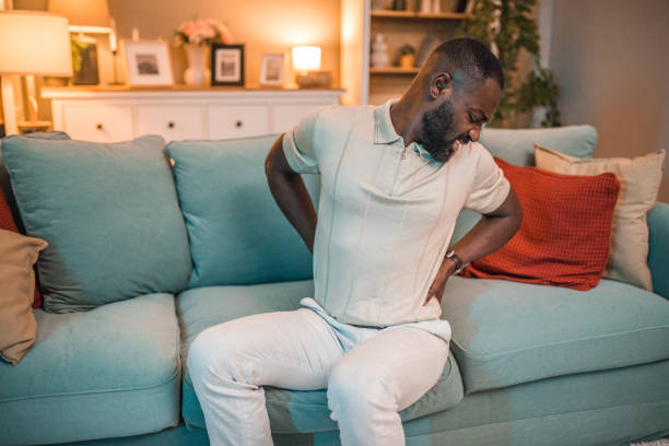 istock A black man has severe back pain due to a physical injury 2199635759