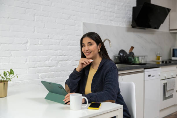 istock Woman working from home in modern kitchen 2199637811