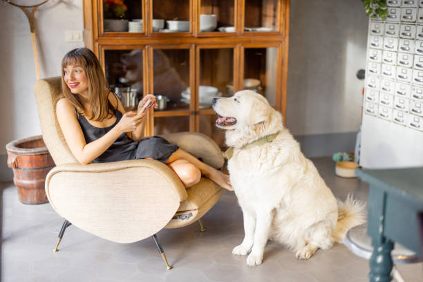 istock Woman Relaxing in Vintage Kitchen with Dog 2199637966