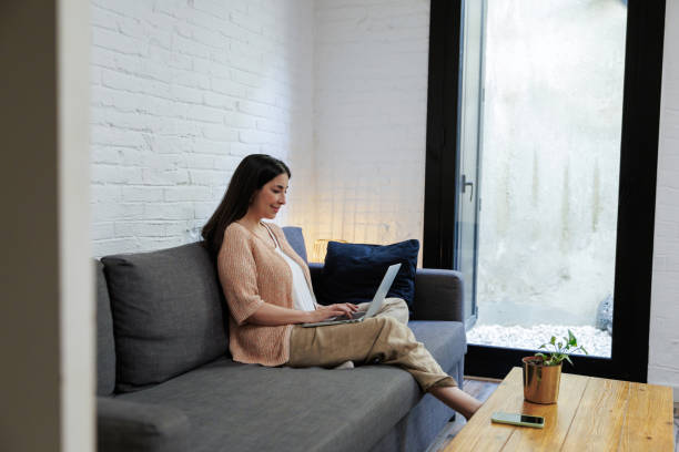 istock Woman working remotely on laptop at home 2199638353