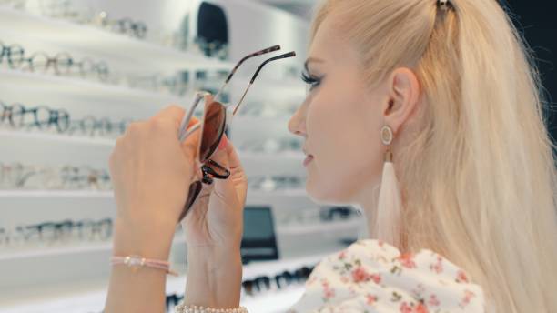 istock Customer choosing sunglasses in optical store 2199638605