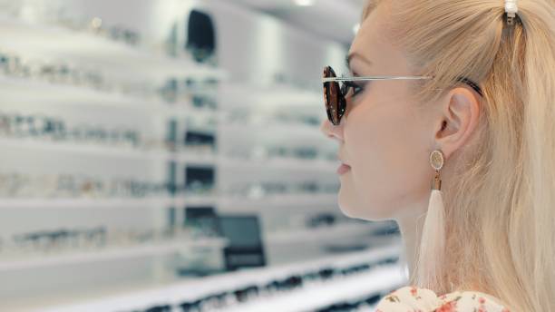 istock Customer choosing sunglasses in optical store 2199638615