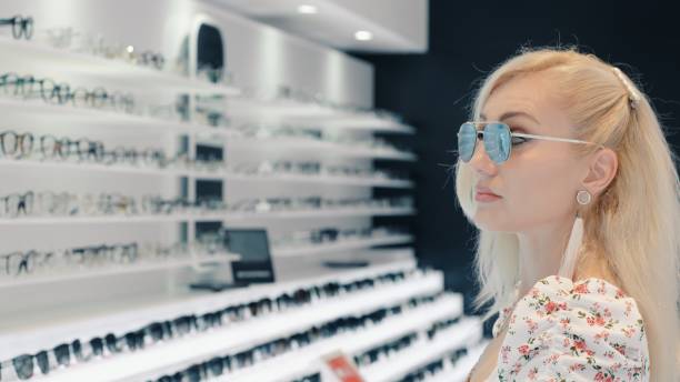 istock Blonde customer wearing sunglasses in optical store 2199638625