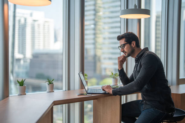 istock A businessman using a laptop in a modern office. 2199640012