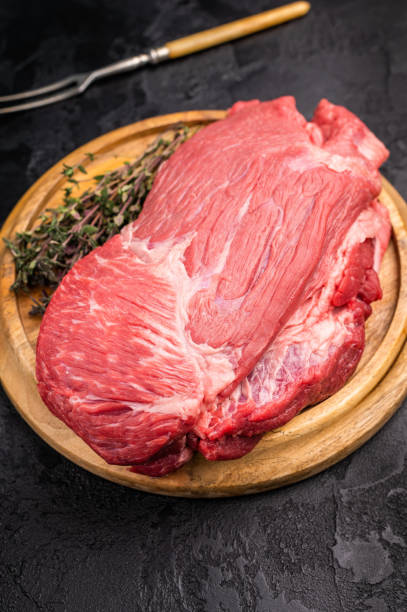 istock Raw Silverside Round beef meat piece , fresh bottom round on wooden board. black background. Top view 2199641632