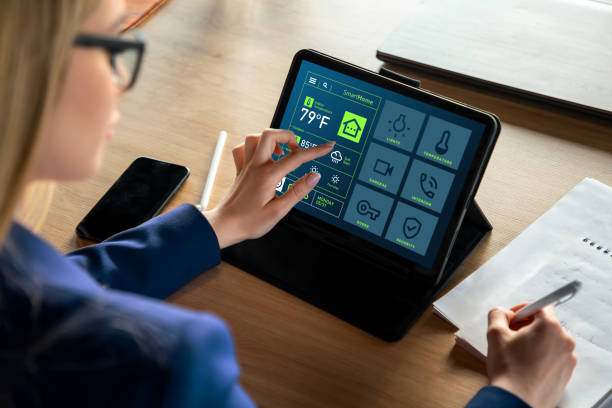 istock Woman Using Tablet with Smart Home App Displaying Temperature in Fahrenheit 2199642181