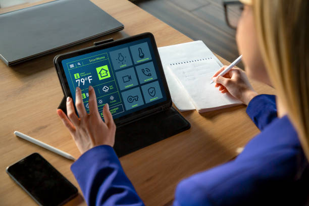 istock Woman Using Tablet with Smart Home App Displaying Temperature in Fahrenheit 2199642198