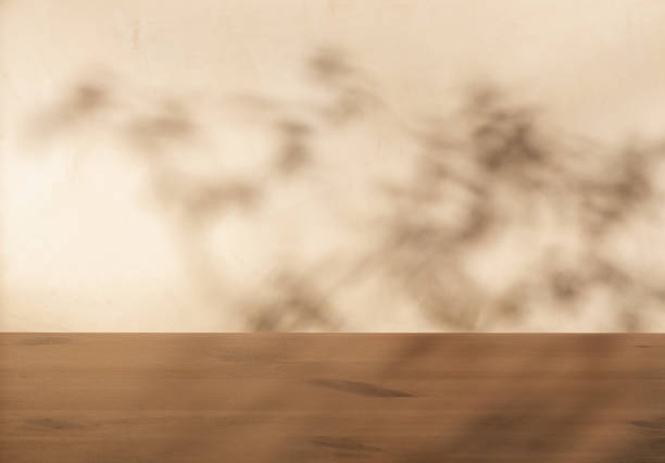 istock Blank soft light beige product display, empty wooden podium with abstract foliage shadow 2199646856