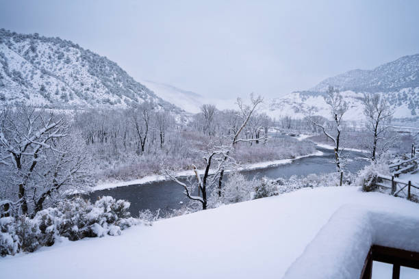 Fresh Snowstorm Scenic Landscape View Along Mountain River - Pristine nature with the Eagle River flowing through mountain valley during snow storm blizzard.