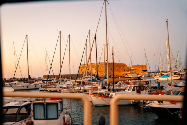 View from the car window on Shipyard at Heraklion with the port and the castle of koule, Crete, Greece
