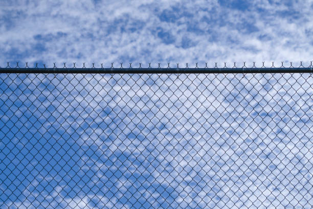 close up on iron chainlink fence against sky
