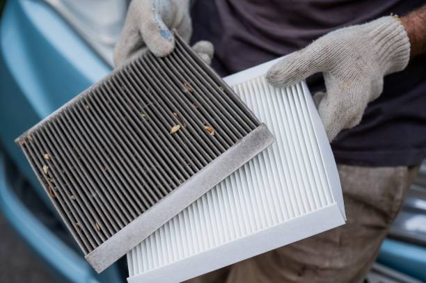 istock The master changes the cabin air filter of the car. 2199652012