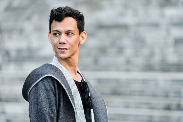 Portrait of confident mid adult man standing outside and looking away