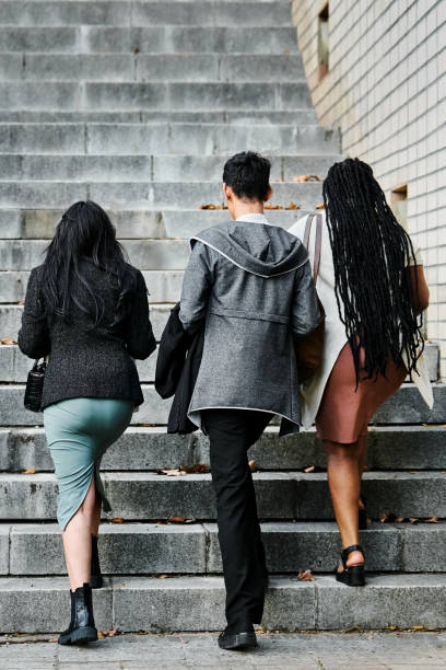 istock Three business professionals walking up city steps 2199655301