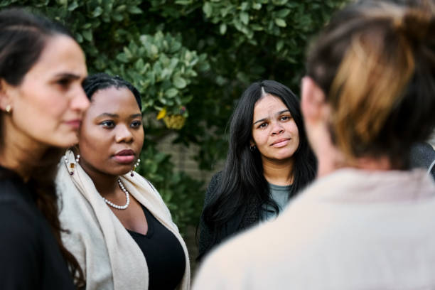 istock Diverse professionals standing and discussing work outdoors 2199655309