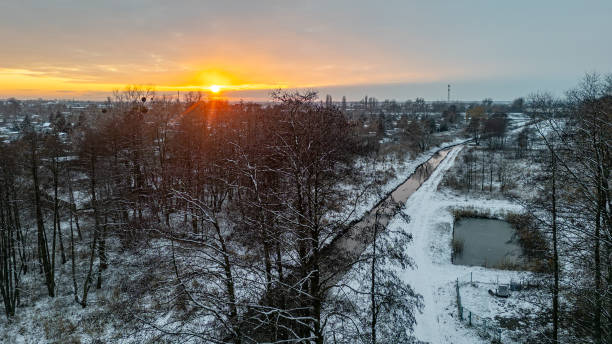 istock winter landscape. aerial view from drone on snow-covered forest and forest river during sunset. 2199657032
