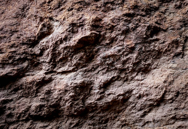 istock Brown rough stone wall for abstract background and texture for interior or exterior design. Beautiful patterns, space for work, banner, wallpaper close up. 2199657986