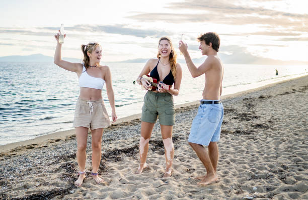 istock Friends having fun on the beach 2199658158