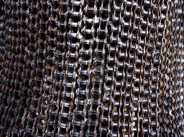 Stacking of rust bicycle chain circle shape background. Used bike chain coiled in spiral textured. Old machinery concept.