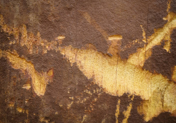 istock Brown rough stone wall with peeling of layer stone surface cracks for abstract background and texture, interior or exterior design. Beautiful patterns, space for work, banner, close up. 2199660618