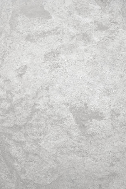 istock Light grey rough stone wall for abstract background and texture for interior or exterior design. Beautiful patterns, space for work, banner, wallpaper close up.Vertical. 2199660619